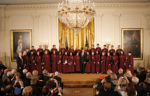 President George W. Bush stands on stage in the East Room of the White House with the Choir of Saint Patrick's Cathedral during a celebration of National Prayer Day Thursday, May 1, 2008. White House photo by Joyce N. Boghosian