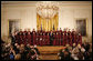 President George W. Bush stands on stage in the East Room of the White House with the Choir of Saint Patrick's Cathedral during a celebration of National Prayer Day Thursday, May 1, 2008. White House photo by Joyce N. Boghosian