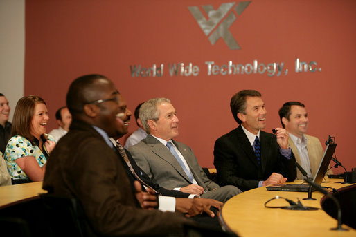 President George W. Bush, seated next to Jim Kavanaugh, right, CEO and co-founder of World Wide Technology, Inc., is shown some of the company's products during a tour of the facility Friday, May 2, 2008, in Maryland Heights, Mo. President Bush also addressed employees and invited guests on the benefit of the stimulus package for the nation's economy. White House photo by Chris Greenberg