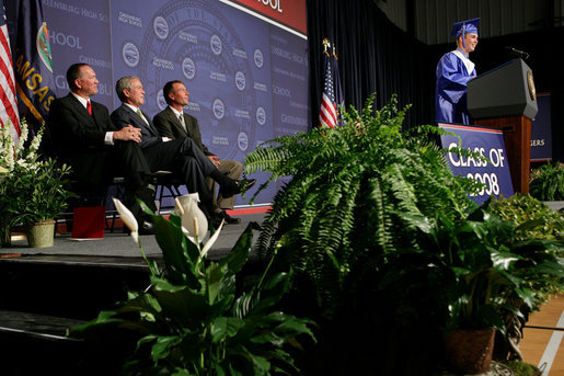 President George W. Bush shares a smile with Superintendent of Greensburg Schools, Darin Headrick, (left), and Greensburg High School Principal Randy Fulton, as Senior Class President Jarrett Schaef gives the Salutorian address during commencement ceremonies for the Greensburg High School Class of 2008. The town of Greensburg, KS was almost entirely destroyed when a tornado tore through the town one year ago today. White House photo by Chris Greenberg