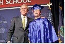 President George W. Bush shares a smile with Aaron Widner after presenting him with his diploma during commencement ceremonies for the Greensburg High School Class of 2008. Aaron has enlisted in the United States Marine Corps and will be attending Basic Training in the months to come. The town of Greensburg, KS was almost entirely destroyed when a tornado tore through the town one year ago today. White House photo by Chris Greenberg