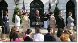 President George W. Bush stands for the national anthem with recipients of the President's Volunteer Service Award during Military Spouse Day ceremonies Tuesday, May 6, 2008, on the South Lawn of the White House. White House photo by Chris Greenberg