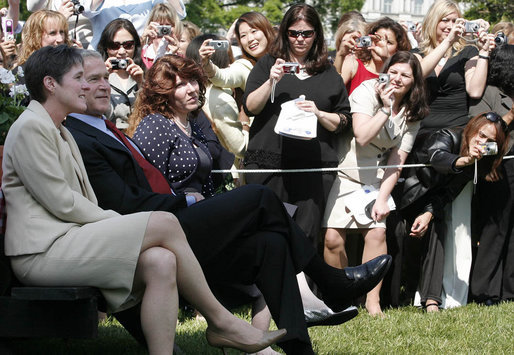 The cameras are turned to President George W. Bush as he sits with Ellen Patton, left, and Colleen Saffron, two of the six recipients of the President's Volunteer Service Award, during Military Spouse Day ceremonies Tuesday, May 6, 2008, on the South Lawn of the White House. White House photo by Joyce N. Boghosian