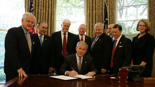 President George W. Bush signs H.R. 5715 into law Wednesday, May 7, 2008, during a ceremony in the Oval Office. The bill, "Ensuring Continued Access to Student Loans Act of 2008," is designed to provide continued availability of access to the Federal student loan program for students and families. Looking on are, from left: Senator Ted Kennedy, (D-MA); Congressman Ruben Hinojosa of Texas; Congressman George Miller of California; Congressman Buck McKeon of California; Senator Mike Enzi, (R-WY); Secretary of Treasury Hank Paulson; Congressman Ric Keller of Florida, and Secretary of Education Margaret Spellings. White House photo by Chris Greenberg