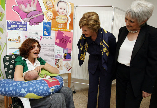 Mrs. Laura Bush and Mrs. Aliza Olmert, spouse of Israel’s Prime Minister Ehud Olmert, greet a young mother in the Breast Feeding Education Room during a visit to the Tipat Chalav-Gonenim Neighborhood Mother and Child Care Center in Jerusalem Wednesday, May 14, 2008. There are 30 similar centers throughout the city providing prenatal, postnatal and preventative care and advice on breastfeeding, nutrition, immunizations and disease screening. White House photo by Shealah Craighead
