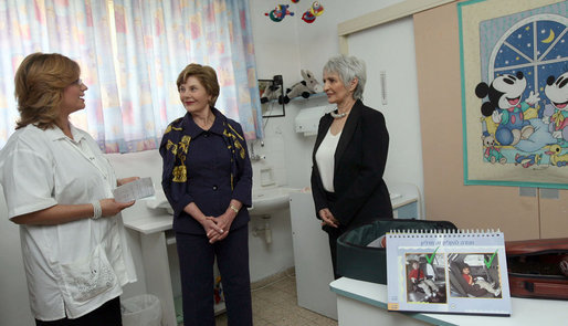 Mrs. Laura Bush and Mrs. Aliza Olmert, spouse of Israeli Prime Minister Ehud Olmert, talk with a staff member during a visit Wednesday, May 14, 2008, to the Tipat Chalav-Gonenim Neighborhood Mother and Child Care Center in Jerusalem. White House photo by Shealah Craighead