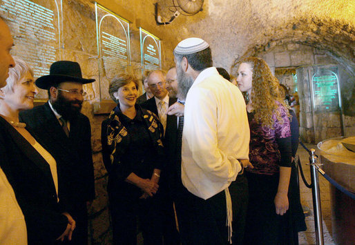 Listening to Mr. Mordechi Eliav as he describes the ongoing construction project that is the Western Wall Tunnels, Mrs. Laura Bush and Mrs. Aliza Olmert, spouse of Israeli Prime Minister Ehud Olmert, participate in a tour of the Jerusalem site. White House photo by Shealah Craighead