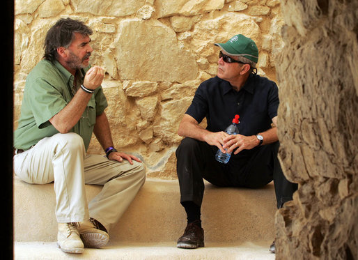 President George W. Bush listens to Eitan Campbell, Director of Masada National Park, as they take a break during their tour Thursday, May 15, 2008, of the historic Israeli fortress located on the eastern fringe of the Judean Desert near the shore of the Dead Sea. White House photo by Joyce N. Boghosian