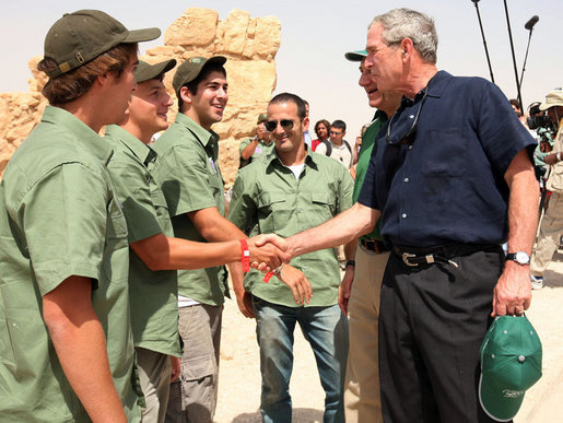 President George W. Bush shakes hands with American students from Connecticut, Massachusetts and California who are volunteering at Masada National Park in Masada, Israel. The President met the young men as he toured the historic site with Prime Minister Ehud Olmert, Mrs. Laura Bush and Mrs. Aliza Olmert. White House photo by Joyce N. Boghosian
