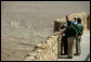 President George W. Bush and Mrs. Laura Bush and Prime Minister Ehud Olmert of Israel and Mrs. Aliza Olmert stand on the upper level of Masada, a palatial fortress built by King Herod, and listen to Eitan Campbell, Director of Masada National Park during their visit to the historic site Thursday, May 15, 2008. On the fringe of the Judean Desert near the shore of the Dead Sea, the camps, fortifications and assault ramp at its base constitute the most complete surviving ancient Roman siege system in the world. White House photo by Shealah Craighead
