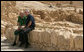 President George W. Bush and Prime Minister Ehud Olmert sit on a wall as they take a break from their tour of Masada Thursday, May 15, 2008. The President and Mrs. Laura Bush took the opportunity to visit the historic site during their two-day visit to Israel to help celebrate the 60 anniversary of the country’s independence. White House photo by Shealah Craighead