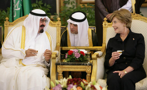 With the help of an interpreter, Mrs. Laura Bush shares a greeting over coffee with King Abdullah bin Abdulaziz during the arrival ceremonies Friday, May 16, 2008, for she and President George W. Bush at the Riyadh-King Khaled International Airport in Riyadh. White House photo by Chris Greenberg