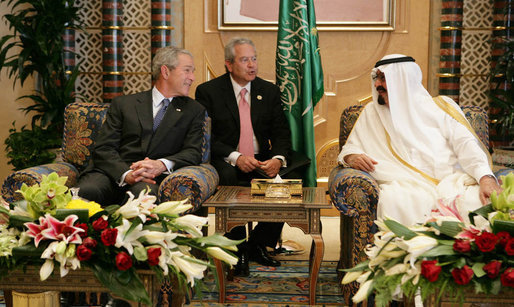 President George W. Bush smiles as he and King Abdullah bin Abdulaziz exchange greetings during a arrival ceremony Friday, May 16, 2008, at the Riyadh-King Khaled International Airport in Riyadh. At center is interpreter Gamal Helal. White House photo by Chris Greenberg