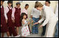 A young girl presents Mrs. Laura Bush with flowers before her departure Sunday, May 18, 2008, following a roundtable discussion with students on Big Read Egypt/U.S. at the Fayrouz Experimental School for Languages at Sharm El Sheikh. White House photo by Shealah Craighead