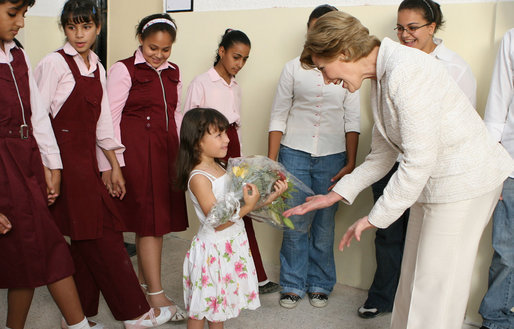 A young girl presents Mrs. Laura Bush with flowers before her departure Sunday, May 18, 2008, following a roundtable discussion with students on Big Read Egypt/U.S. at the Fayrouz Experimental School for Languages at Sharm El Sheikh. White House photo by Shealah Craighead