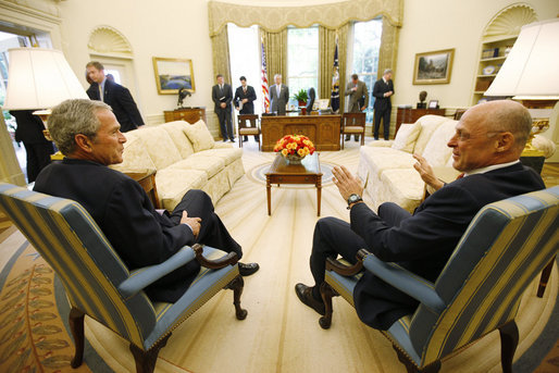 President George W. Bush and U.S. Treasury Secretary Henry Paulson talk together during their meeting on economic issues Monday morning, May 19, 2008, in the Oval Office. White House photo by Eric Draper