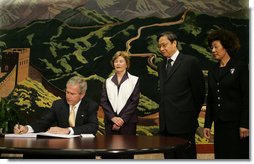 President George W. Bush signs his condolences for the victims of China's May 12 earthquake as he and Mrs. Laura Bush visit the Embassy of the People's Republic of China Tuesday, May 20, 2008, in Washington, D.C. With them are China's Ambassador to the United States Wenzhong Zhou and his spouse, Shumin Xie. White House photo by Joyce N. Boghosian