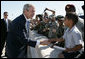 President George W. Bush greets a young boy on his arrival to Pope Air Force Base in Fort Bragg, N.C., Thursday, May 22, 2008. White House photo by Chris Greenberg