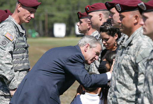 President George W. Bush honors Erika Wyckoff and her children, wife of Sgt. Charles Wyckoff, after she received her husband's posthumous Distinguished Service Cross for extraordinary heroism in action, presented by President Bush Thursday, May 22, 2008, during ceremonies at the 82nd Airborne Division Review in Fort Bragg, N.C. White House photo by Chris Greenberg