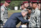 President George W. Bush honors Erika Wyckoff and her children, wife of Sgt. Charles Wyckoff, after she received her husband's posthumous Distinguished Service Cross for extraordinary heroism in action, presented by President Bush Thursday, May 22, 2008, during ceremonies at the 82nd Airborne Division Review in Fort Bragg, N.C. White House photo by Chris Greenberg
