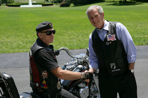 President George W. Bush poses for a photo with National Executive Director of Rolling Thunder Artie Muller at the conclusion of a visit by the motorcycle group to the White House. White House photo by Chris Greenberg