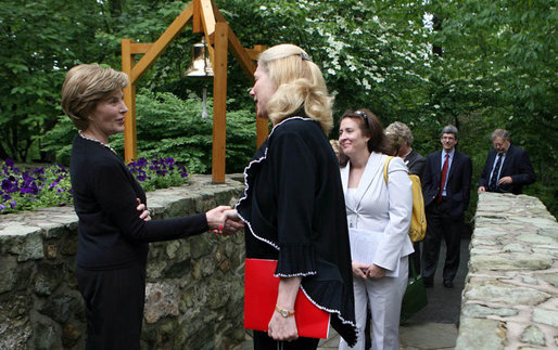 Mrs. Laura Bush greets the directors of Presidential Libraries Wednesday, June 4, 2008, at the entrance to Camp David's Evergreen Chapel in Thurmont, Maryland. Mrs. Bush shakes hands with Ms. Nancy Smith, Director of the National Archives' Presidential Material Staff in Alexandria, VA. White House photo by Shealah Craighead