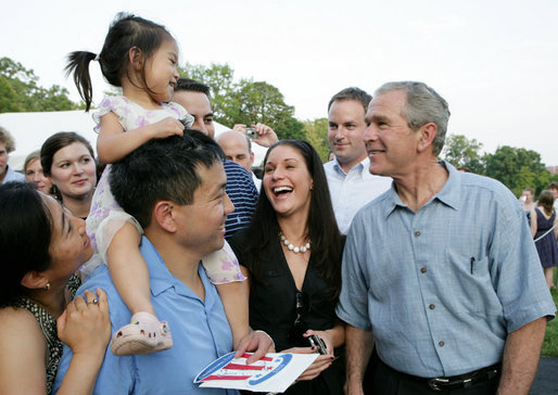 President George W. Bush stops to meet a young guest and her family at the annual Congressional Picnic on the South Lawn of the White House, Thursday evening, June 5, 2008, for members of Congress and their families. White House photo by Chris Greenberg