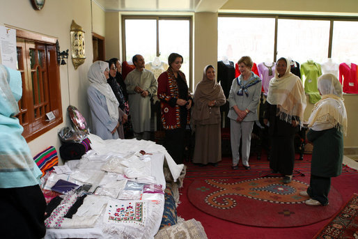 Mrs. Laura Bush speaks with Afghan women entrepreneurs during her visit to the marketplace of Arzu and Bamiyan Women's Business Association Sunday, June 8, 2008, in Afghanistan. White House photo by Shealah Craighead
