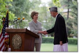 Mrs. Laura Bush shakes hands with President Hamid Karzai of Afghanistan, Sunday, June 8, 2008, during their press availability at the presidential palace in Kabul.  White House photo by Shealah Craighead