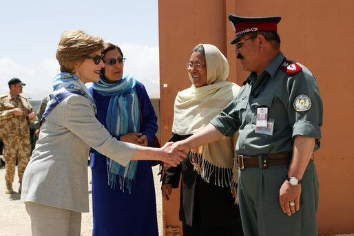 Governor Habiba Sarabi, center, introduces Mrs. Laura Bush to Col. Hafizullah Paymon, Commander of the Afghan Regional Training Center, during a visit to the Police Training Academy in Bamiyan, Afghanistan there Sunday, June 8, 2008. White House photo by Shealah Craighead