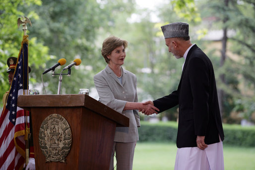 Mrs. Laura Bush shakes hands with President Hamid Karzai of Afghanistan, Sunday, June 8, 2008, during their press availability at the presidential palace in Kabul. White House photo by Shealah Craighead