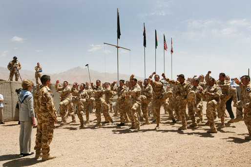 Mrs. Laura Bush is greeted Sunday, June 8, 2008, by New Zealand troops performing a traditional warrior dance at the Bamiyan Provincial Reconstruction Team Base in Afghanistan’s Bamiyan province. Standing with her is Major Justin de la Haye. White House photo by Shealah Craighead