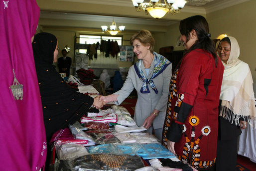 Mrs. Laura Bush greets local businesswomen as she tours the marketplace of the Arzu and Bamiyan Women’s Business Association on June 8, 2008 in Afghanistan. The carpets, embroidery and other Afghan wares are all made by women. White House photo by Shealah Craighead