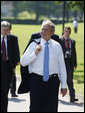 President George W. Bush walks carrying his jacket over his shoulder on his way to a meeting with European Union leaders Tuesday, June 10, 2008 at Brdo Castle in Kranj, Slovenia. White House photo by Eric Draper
