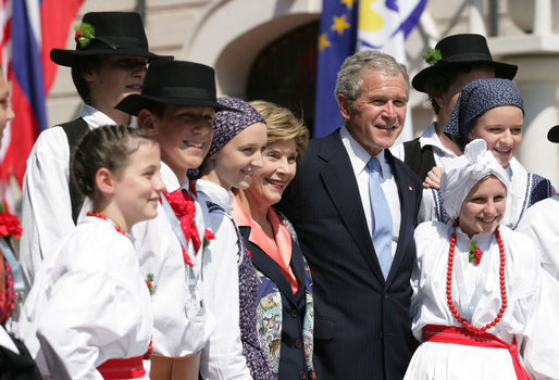 President George W. Bush and Laura Bush pose for a photo with children dressed in traditional outfits during their visit Tuesday, June 10, 2008, to the Lipizzaner Horse Exhibition at Brdo Castle in Kranj, Slovenia. White House photo by Shealah Craighead