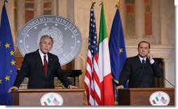 President George W. Bush and Italian Prime Minister Silvio Berlusconi listen to a reporter's question during their joint press availability Thursday, June 12, 2008, at the Villa Madama in Rome. White House photo by Chris Greenberg