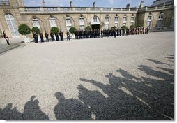 The media's shadow drops across the courtyard of the Elysée Palace in Paris Saturday, June 14, 2008, as the honor cordon and color guard prepare for the arrival of President George W. Bush, who spent the morning with France's President Nicolas Sarkozy. White House photo by Chris Greenberg