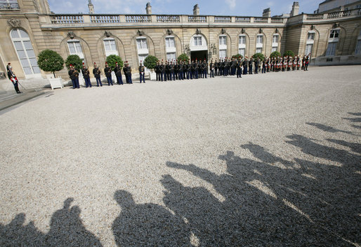 The media's shadow drops across the courtyard of the Elysée Palace in Paris Saturday, June 14, 2008, as the honor cordon and color guard prepare for the arrival of President George W. Bush, who spent the morning with France's President Nicolas Sarkozy. White House photo by Chris Greenberg