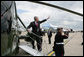 President George W. Bush waves on his arrival at London's Heathrow International Airport Sunday, June 15, 2008, boarding Marine One for a flight to Windsor Castle to meet Queen Elizabeth II. White House photo by Chris Greenberg