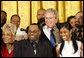 President George W. Bush joins singers Narcissus Brown, left, Kurt Carr, Spensha Baker and Walter Hawkins on stage in the East Room of the White House, following their performances Tuesday, June 17, 2008, in honor of Black Music Month. White House photo by Eric Draper