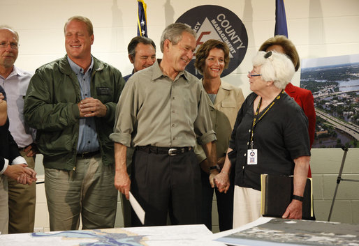 President George W. Bush holds the hand of Cedar Rapids Mayor Kay Halloran during a briefing on the Iowa flooding Thursday, June 19, 2008, at the Lynn County Training and Response Center in Cedar Rapids. White House photo by Eric Draper
