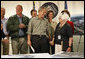 President George W. Bush holds the hand of Cedar Rapids Mayor Kay Halloran during a briefing on the Iowa flooding Thursday, June 19, 2008, at the Lynn County Training and Response Center in Cedar Rapids. White House photo by Eric Draper