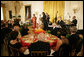 President George W. Bush joins invited guests Thursday evening, June 19, 2008 to the East Room of the White House, listening to vocalist Esther Williams and saxophonist Davey Yarborough during a social dinner in honor of American jazz. White House photo by Chris Greenberg