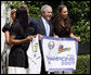 President George W. Bush, joined by Diana Taurasi, left, and Cappie Pondexter, is presented a Phoenix Mercury Championship banner and a personalized team jersey Monday, June 23, 2008, during the 2007 WNBA Champions, the Phoenix Mercury, visit to the White House. White House photo by Eric Draper