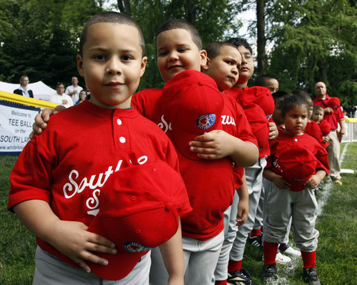 Players of the Cramer Hill Little League Red Sox of Camden, New Jersey hold their hats over their hearts during the singing of the National Anthem at the 2008 Tee Ball on the South Lawn Season Opener Monday, June 30, 2008, on the South Lawn of the White House. White House photo by Eric Draper
