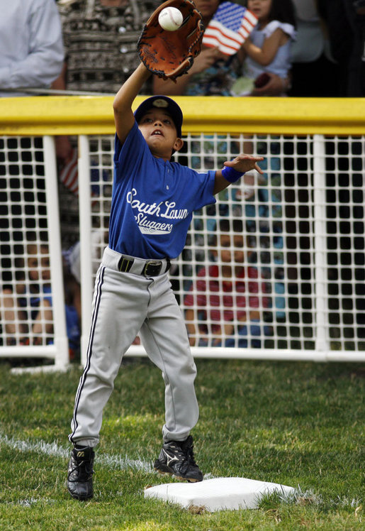 The first baseman of the Jose M. Rodriguez Little League Angels from Manati, Puerto Rico reaches up to catch the ball during the season opener of the 2008 Tee Ball on the South Lawn Monday, June 30, 2008, on the South Lawn of the White House. White House photo by Eric Draper
