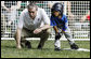 U.S. Secretary of Commerce Carlos Gutierrez coaches a player on third base of the Jose M. Rodriguez Little League Angels of Manati, Puerto Rico, during the 2008 Tee Ball on the South Lawn Season Opener Monday, June 30, 2008, on the South Lawn of the White House. White House photo by Eric Draper