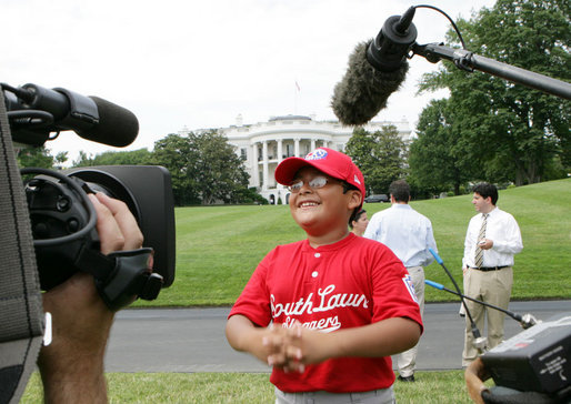 A player with the Cramer Hill Little League Red Sox of Camden, N.J., is the center of media attention on the South Lawn of the White House after playing Monday, June 30, 2008, in the opening game of the 2008 Tee Ball on the South Lawn, with his teammates against the Jose M. Rodriguez Little League Angels of Manati, Puerto Rico. White House photo by Chris Greenberg