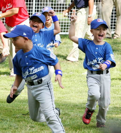 Players of the Jose M. Rodriguez Little League Angels of Manati, Puerto Rico, jubilate at the conclusion of the 2008 Tee Ball game on the South Lawn Season Opener Monday, June 30, 2008, on the South Lawn of the White House. White House photo by Joyce N. Boghosian