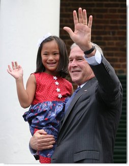President George W. Bush holds Julia White Freeman, formerly of China, after she took the Oath of Citizenship at Monticello's 46th Annual Independence Day Celebration and Naturalization Ceremony Friday, July 4. 2008, in Charlottesville, VA. White House photo by Joyce N. Boghosian